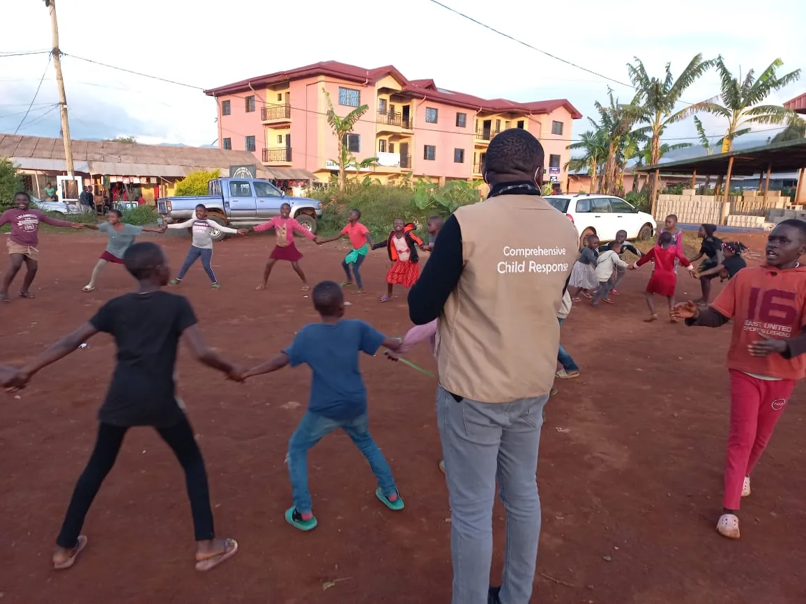 Kingsley Udo leading children in a circle game in Cameroon