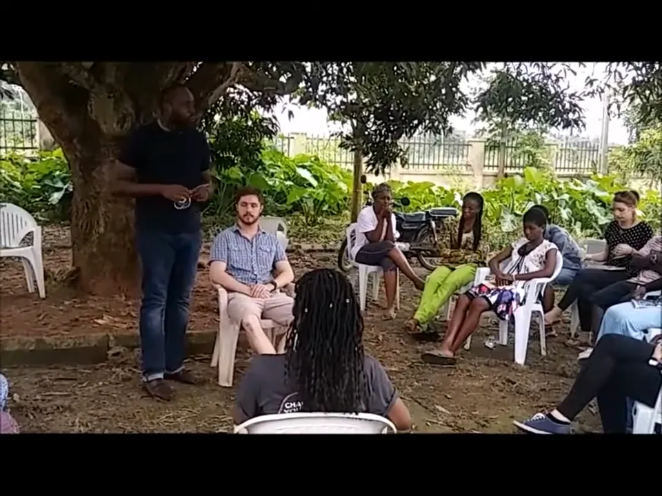Kingsley Udo leading a child protection training under a tree